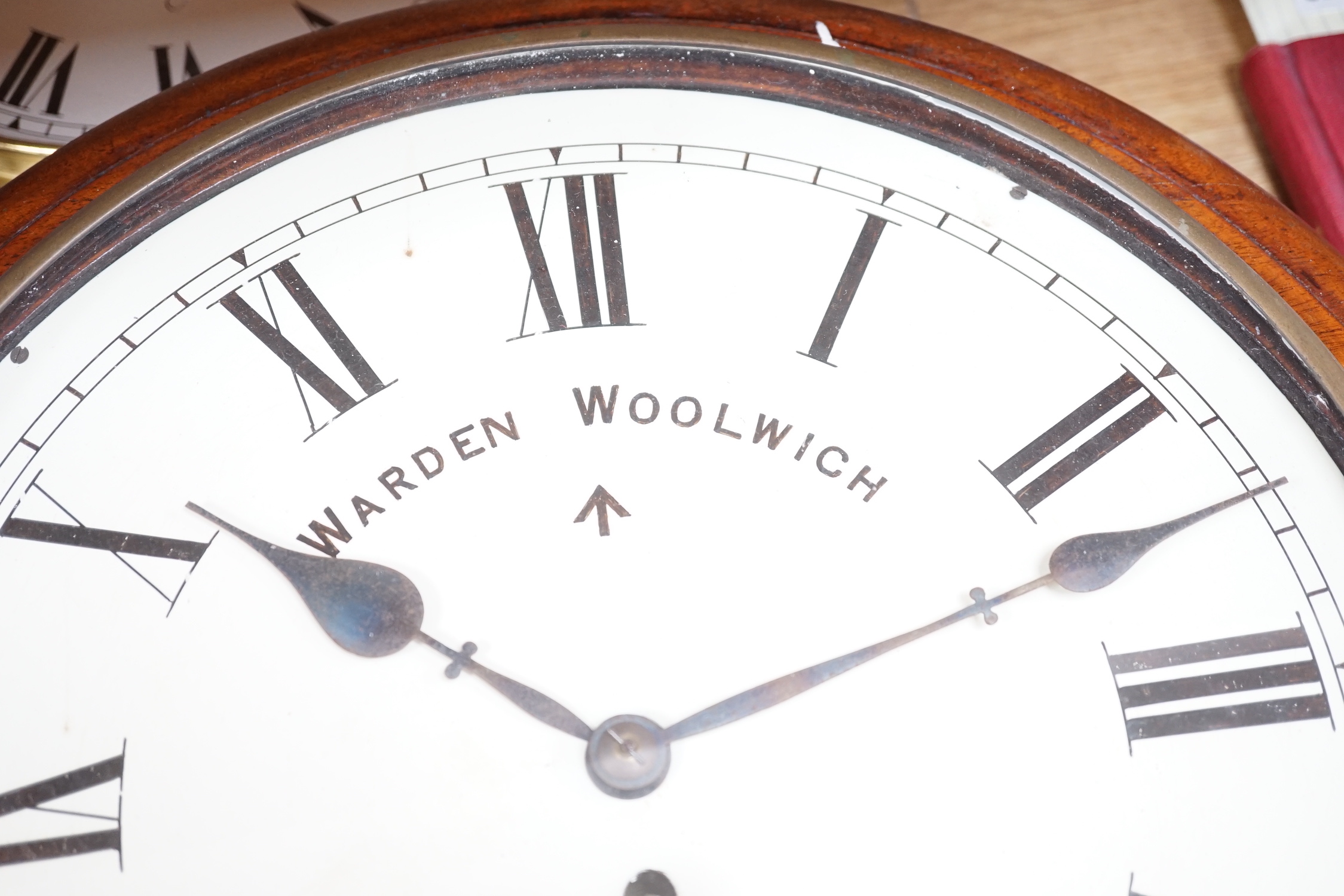 An Edwardian mahogany single fusee wall timepiece, The dial signed Warden Woolwich, the movement stamped Warren 1903/52 and later clock by Ernest N. Gibbs, London (2), largest 46cm diameter